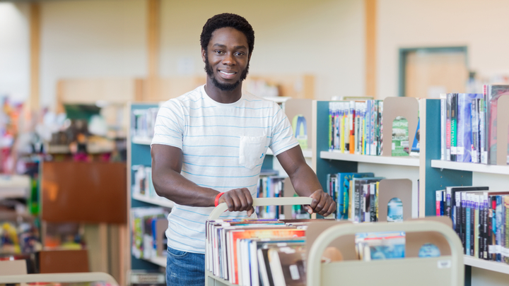 library-man-pushing-cart-books.jpg