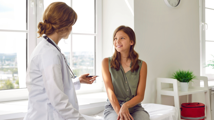 Doctor talking to teenage girl