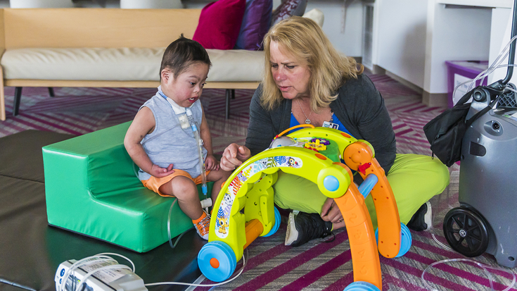 OSF Children's Hospital of Illinois nurse playing with a toy and patient