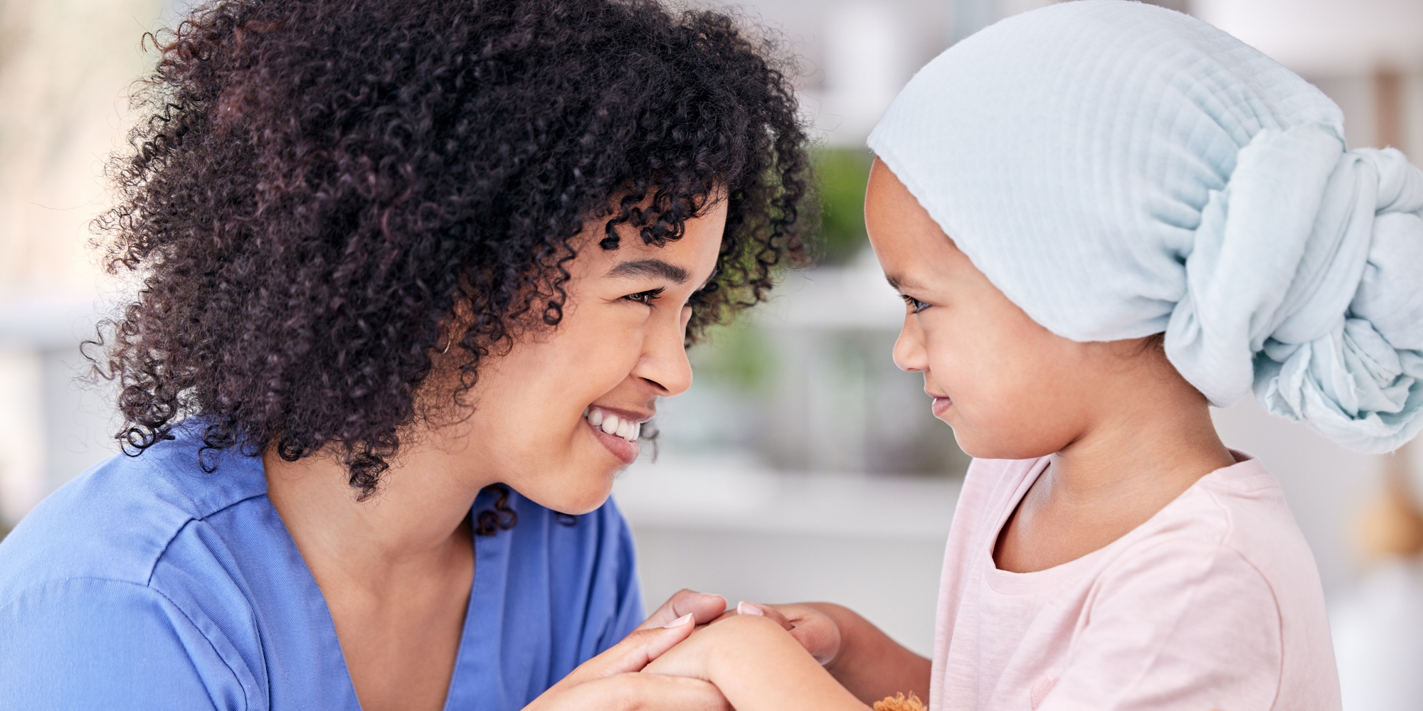 Nurse and child holding hands