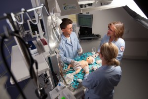 Care team performing simulation with pediatric manikin