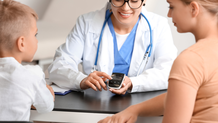 Diabetic boy with mother visiting doctor in clinic