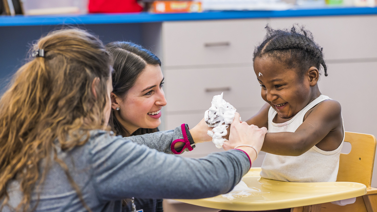 Pediactric physical therapists interacting with child