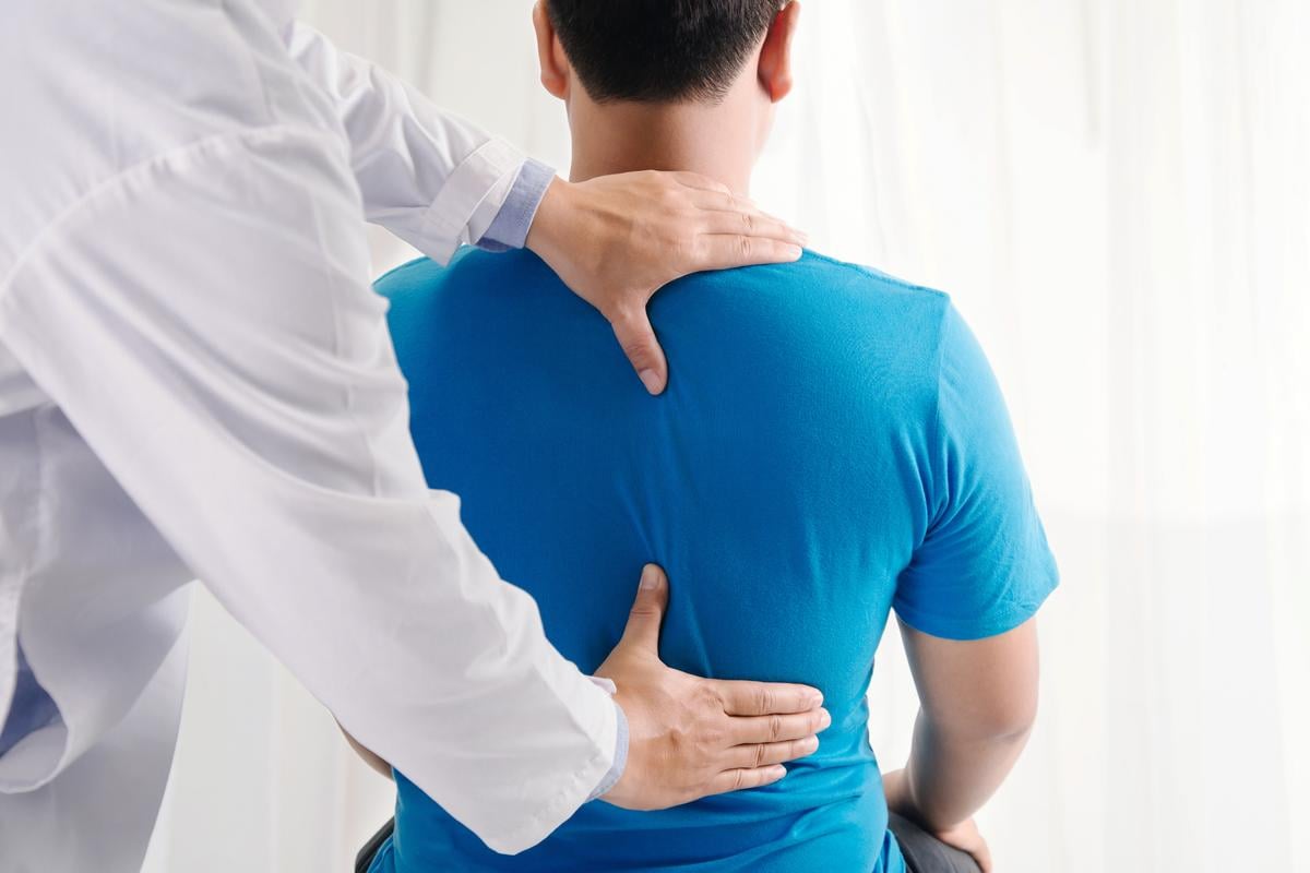 Doctor examining a patient's spine