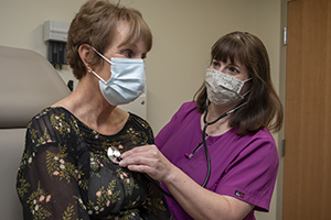 Physician listens to patient breathing
