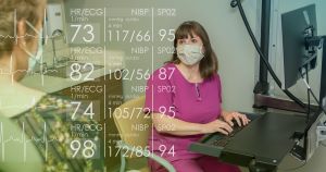 Physician charting patient info at computer