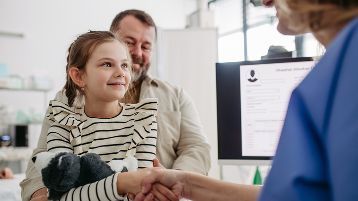 Young girl shaking hands with provider