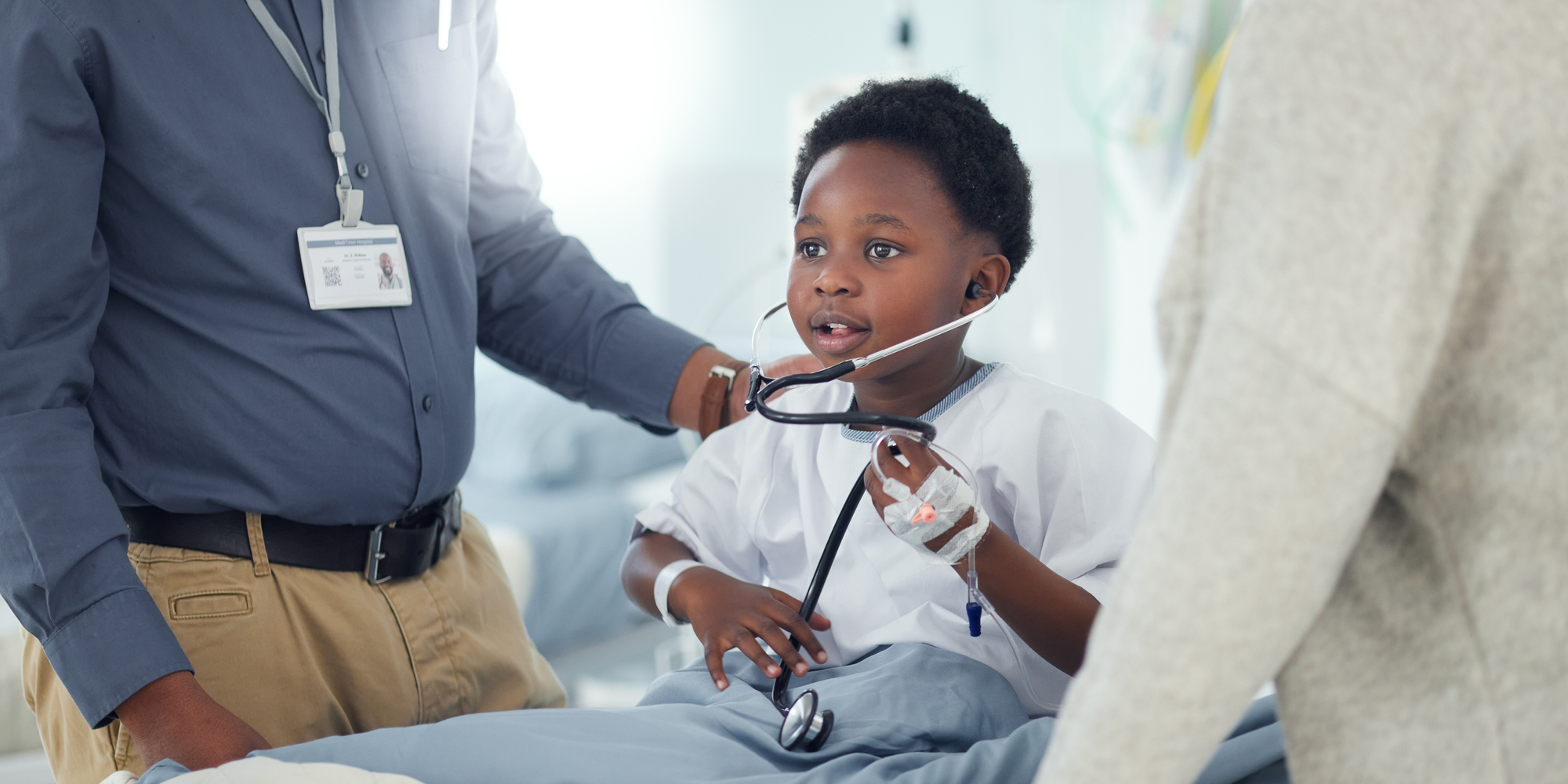 child playing with stethoscope hospital
