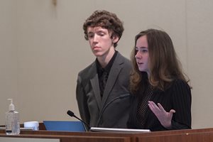 Student interns present at podium