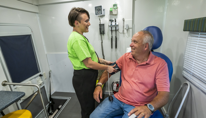 Male patient getting blood pressure checked in OnCall King-Care-A-Van