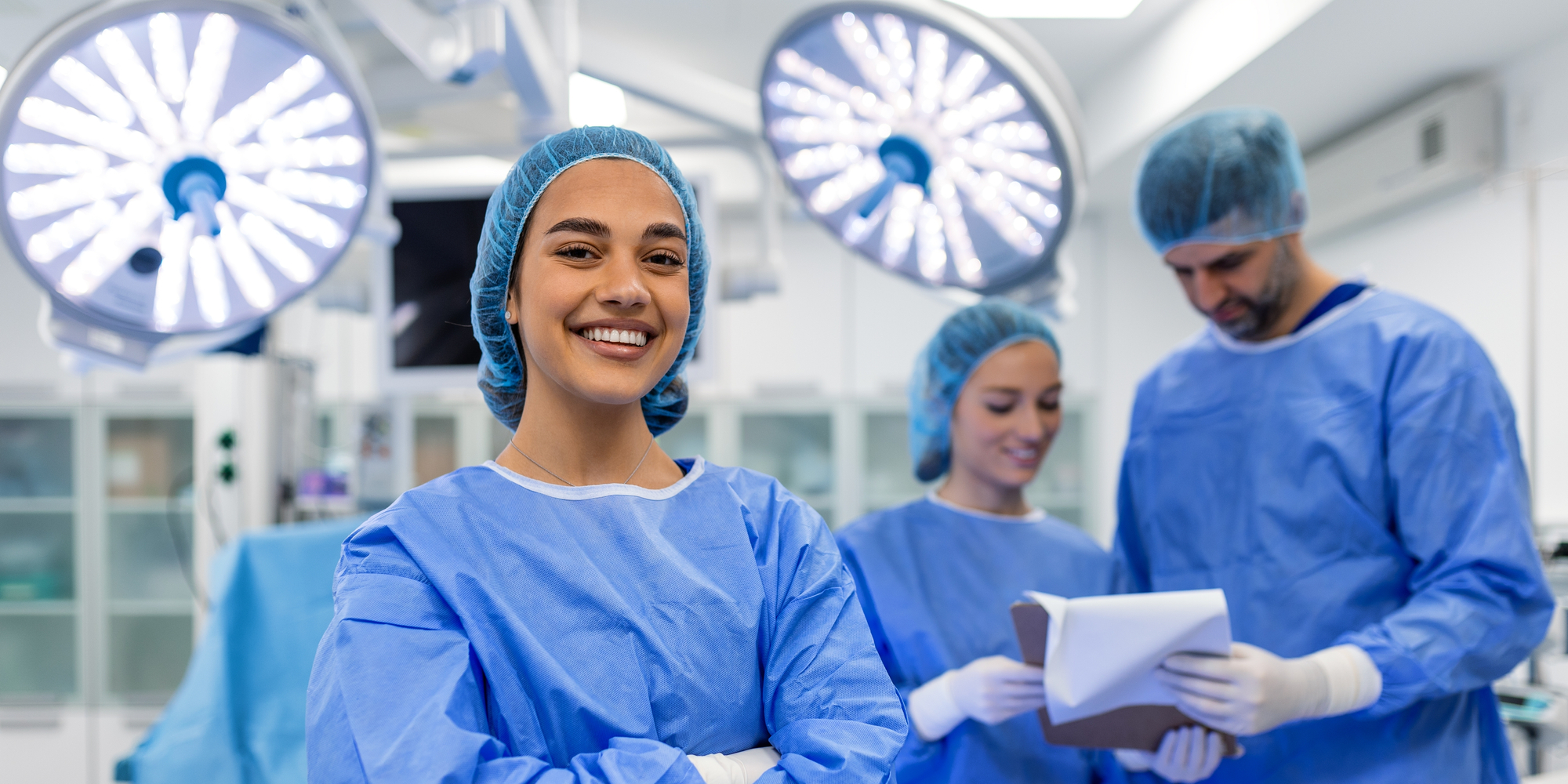 Surgeon with Fellows in OR Smiling