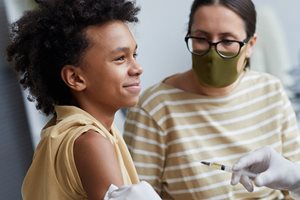 Young male patient and parent receiving immunization