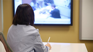 Physician looking at videos on screen
