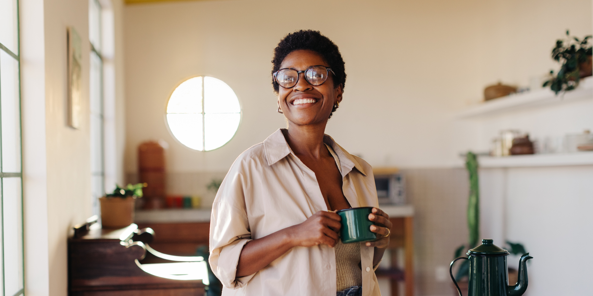 Young Woman Smiles With a Green Mug