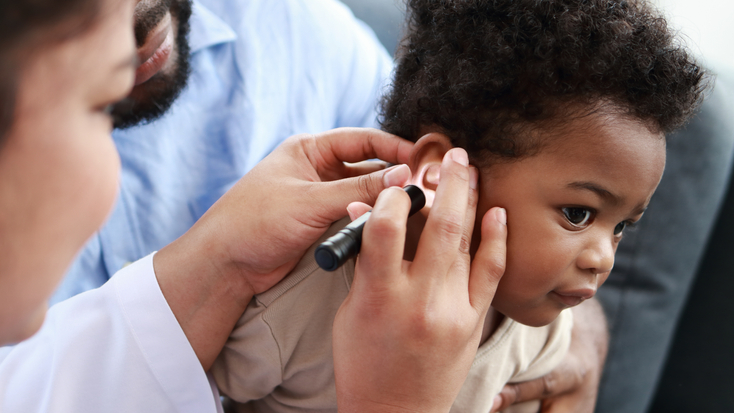 Young African American child getting an ear examination