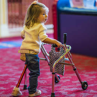 Adalie Guth uses a walker to help with her balance, and remains independent thanks to therapy and family support.