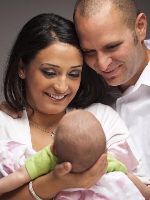 Couple holding infant