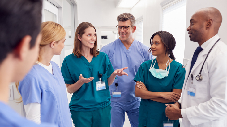 Medical Team Having Meeting In Hospital Corridor