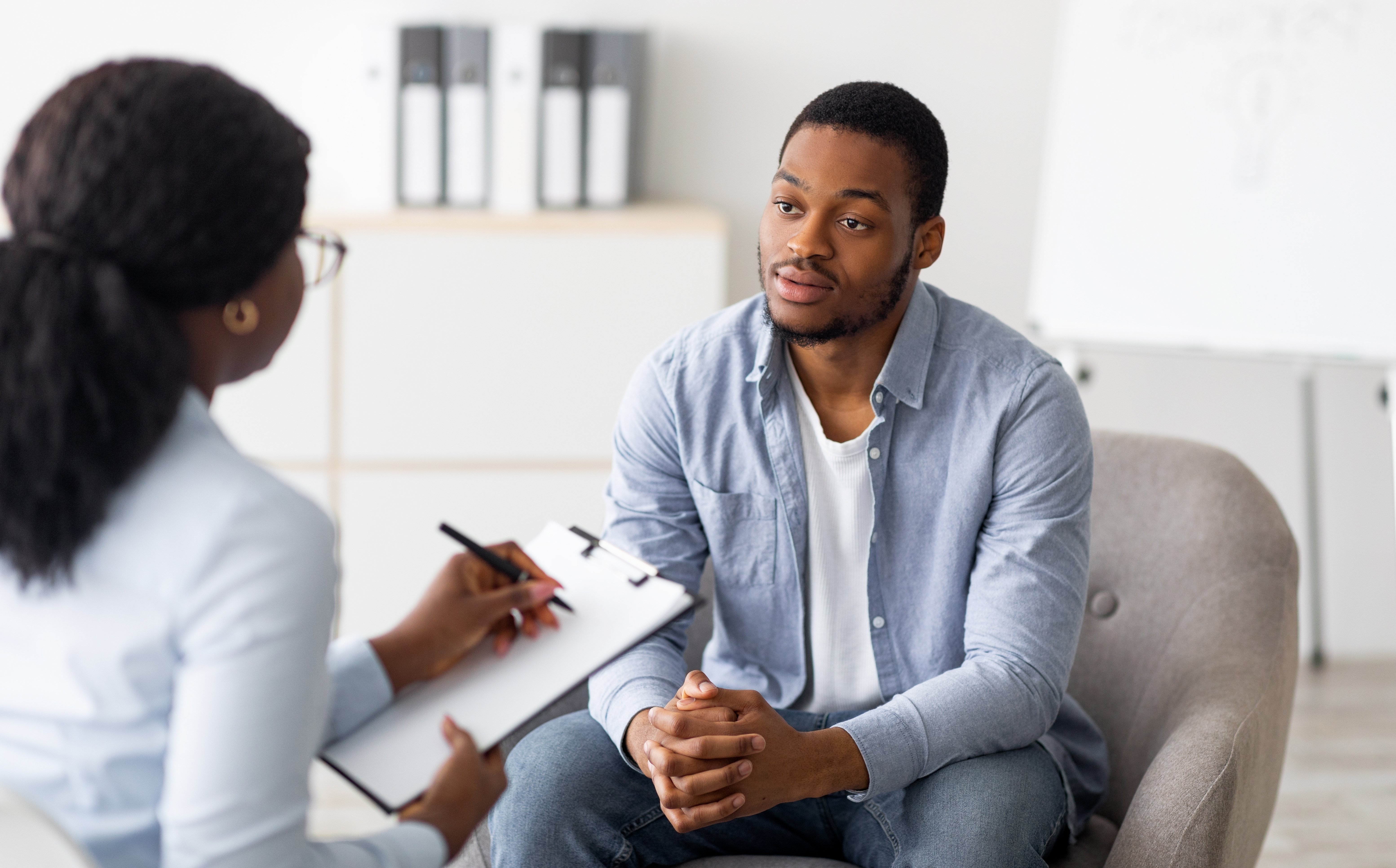 Patient talking about skin cancer screening with doctor