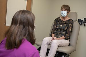 Patient speaking to physician in a clinic setting