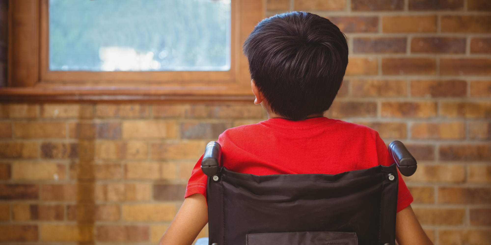 rear-view-little-boy-sitting-wheelchair-256321942.jpg