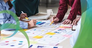 Hands work around materials in meeting