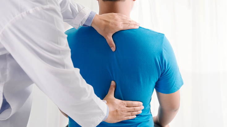 Doctor examining a patient's spine