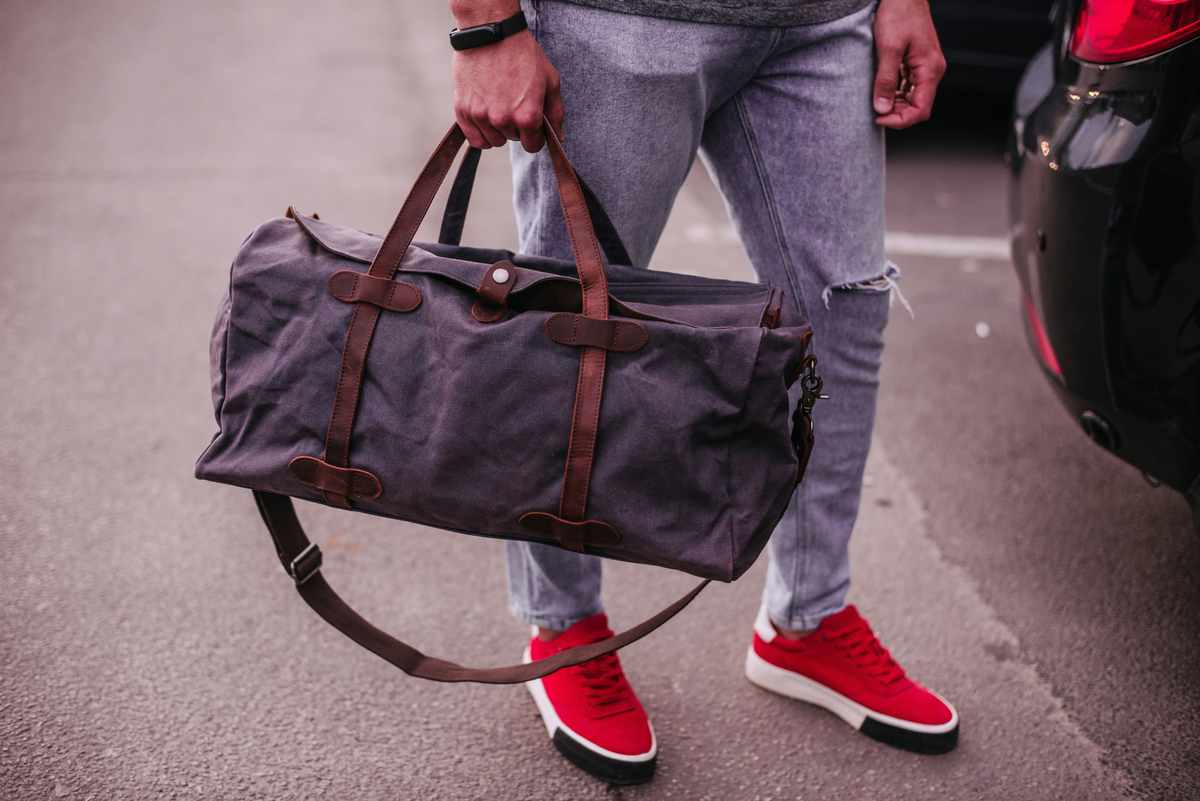 Man Holds a Luggage Bag