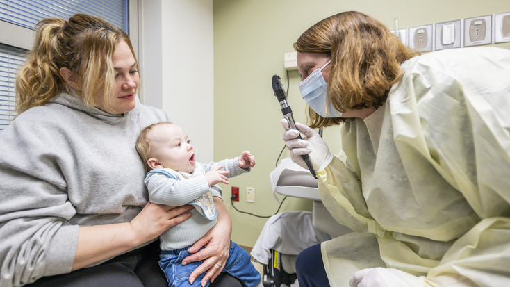 Baby Being Examined by a Nurse