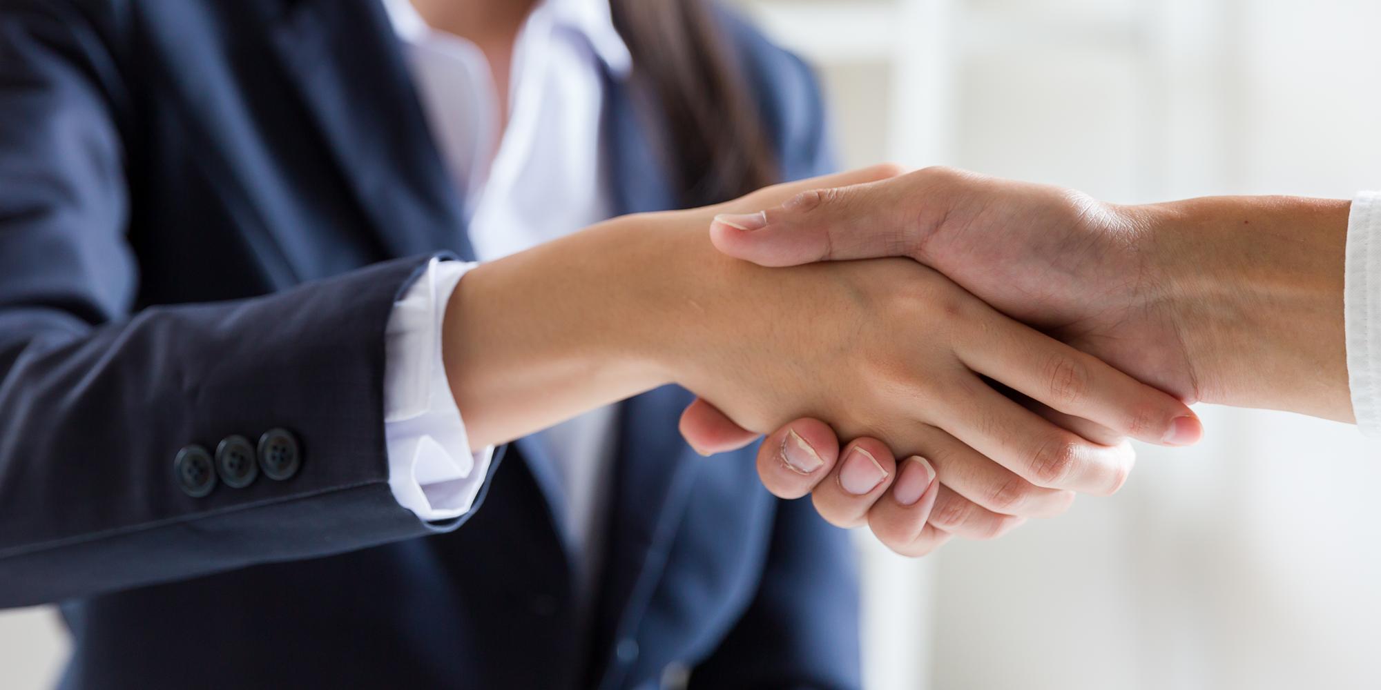 Business people shake hands