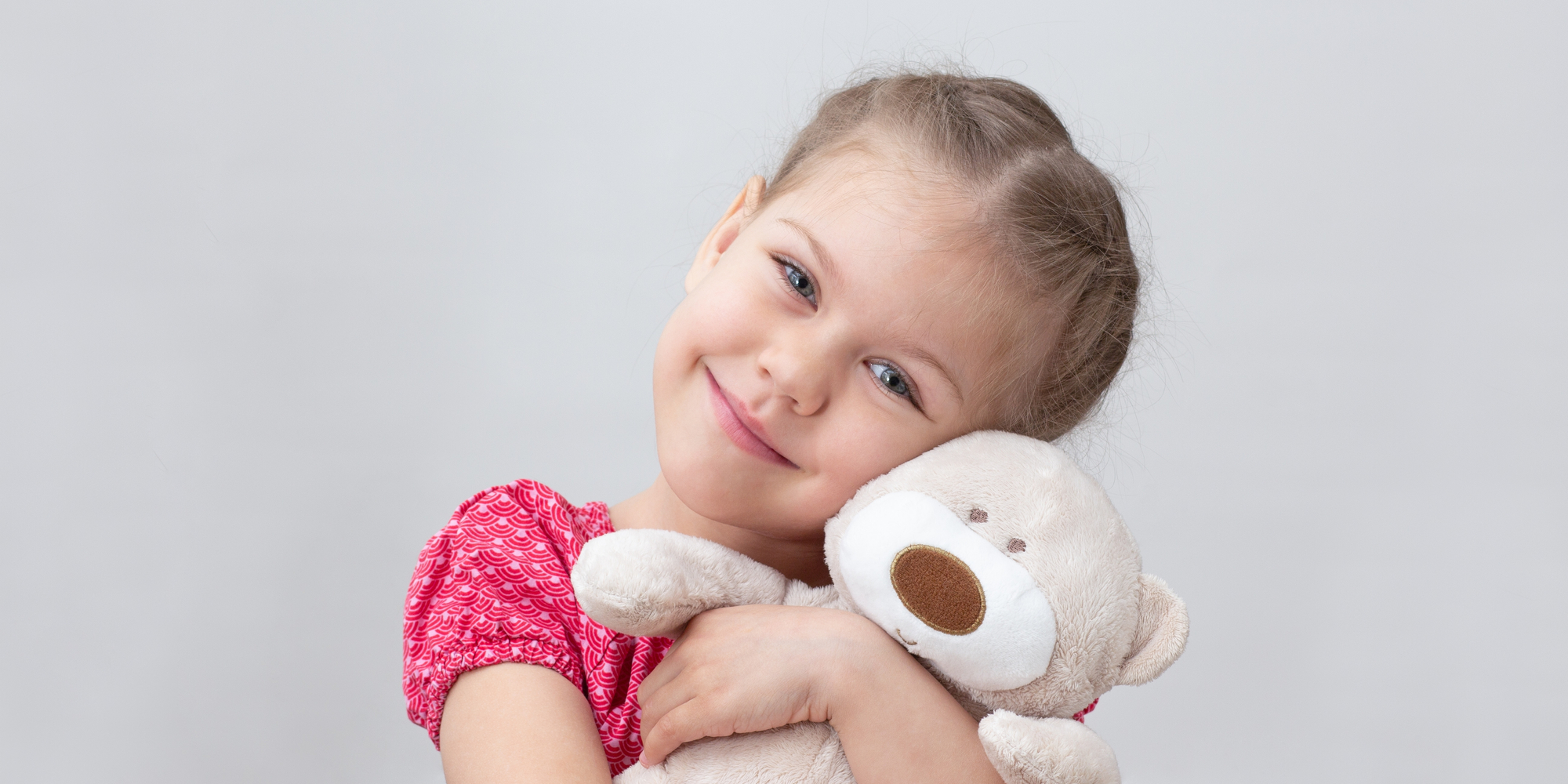 happy child hugging teddy bear
