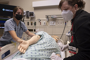 Care team working with manikin