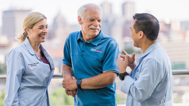 Neurosurgeons talking with patient