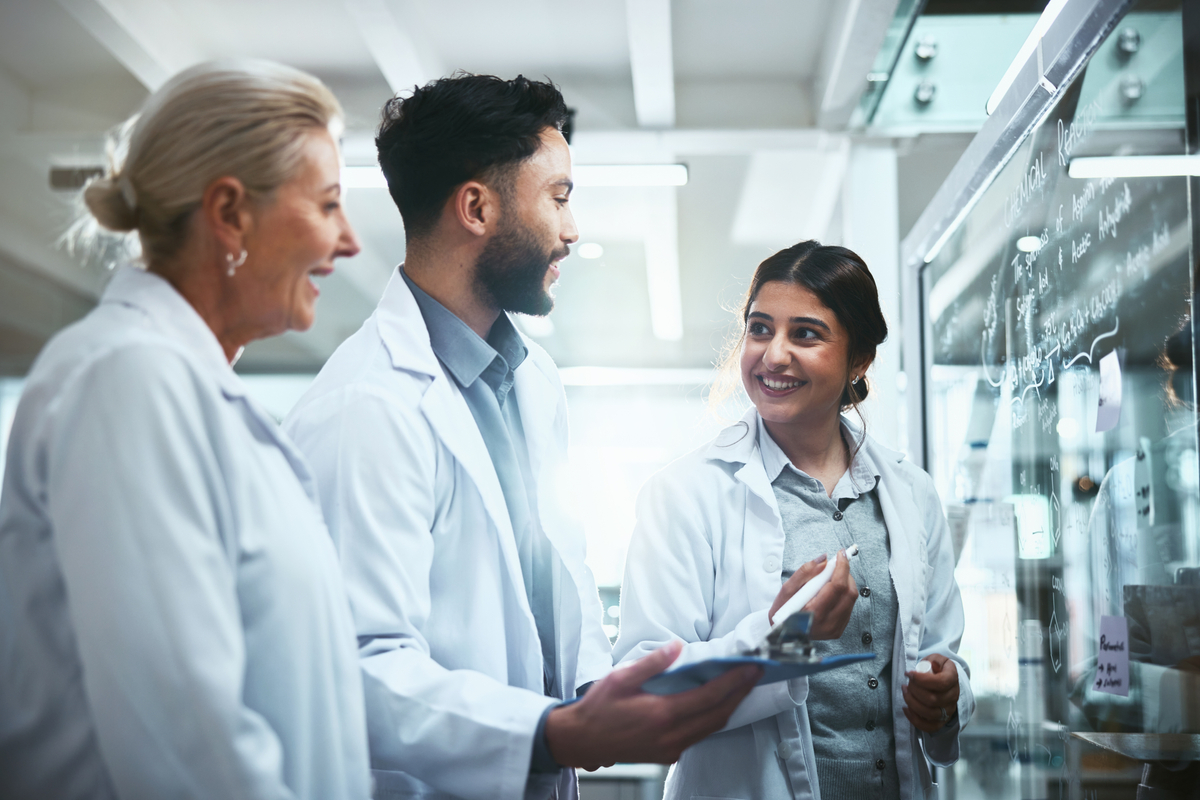 Research scientists writing on glass