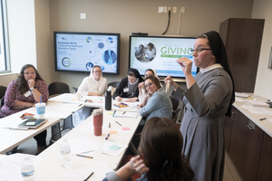 Sister Speaking to a Room of Mission Partners