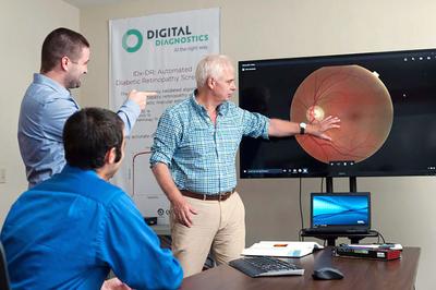Professionals work with digital diagnostic on screen