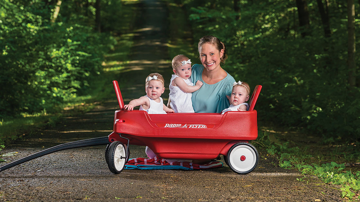 Triplets in wagon with mom