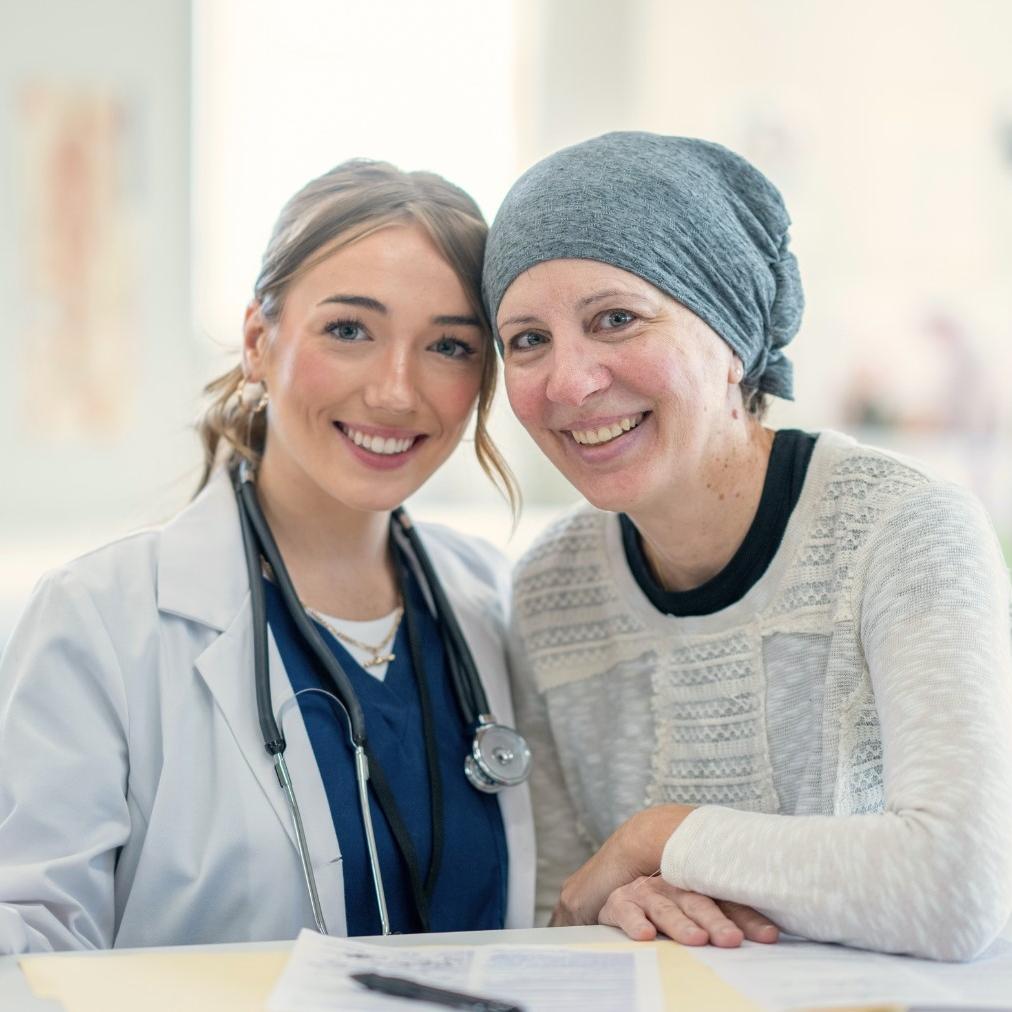 Female doctor smiling with cancer patient