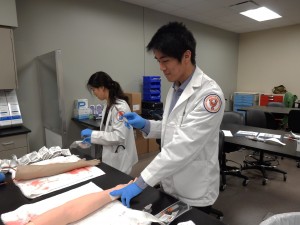 Medical students work with skills trainers