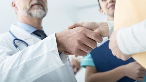 Physician Shaking Hands With Patient