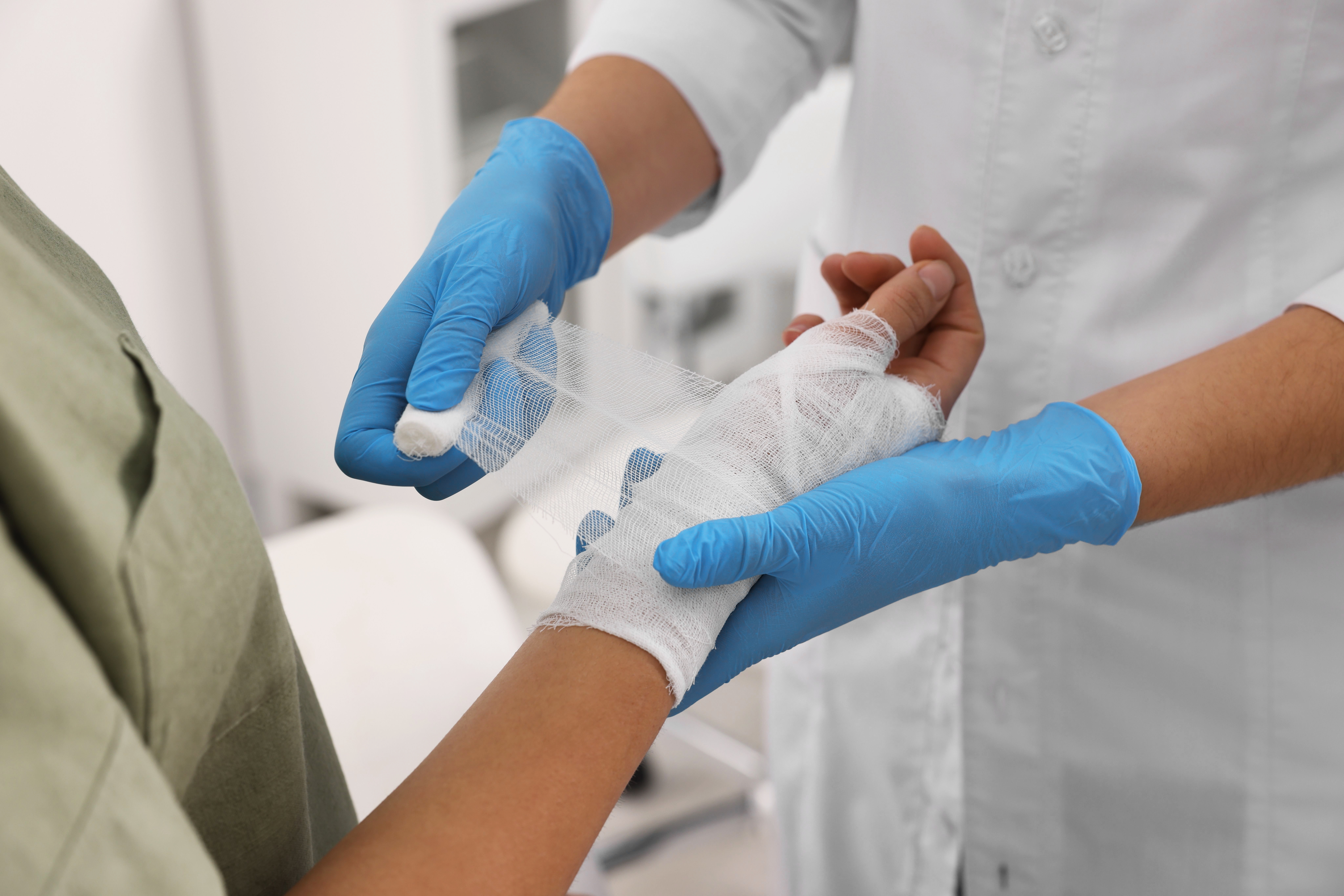 doctor-bandaging-patients-hand.jpg