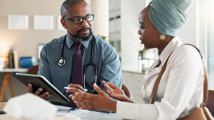 black woman with doctor in hospital for medical diagnosis
