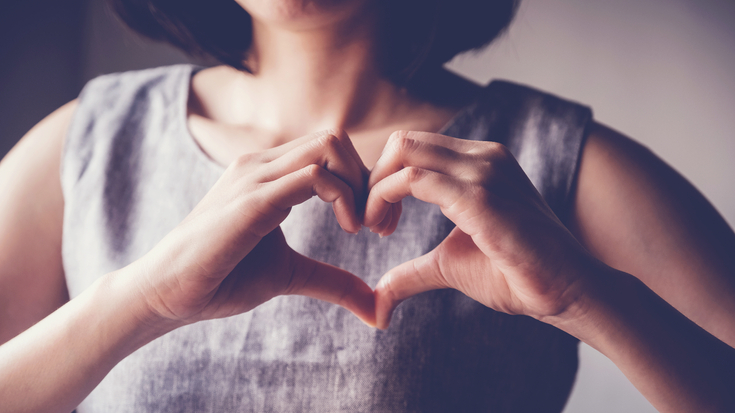 Woman Creating Heart Sign With Hands