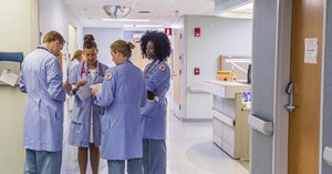 Care team meeting in hospital hallway