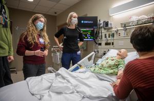 Nurses run simulation in mock patient room with a manikin