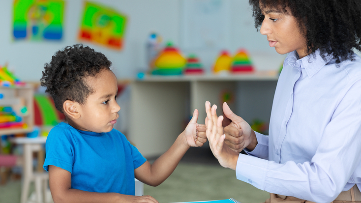 A young student practicing counting and fine motor skills during a one-on-one session with a private teacher or child development specialist.